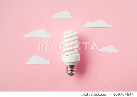 Light bulb with white cut out clouds. Idea concept 109764644