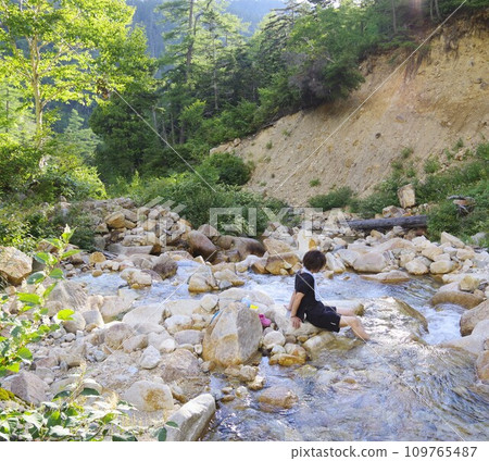 woman cooling off in the river 109765487