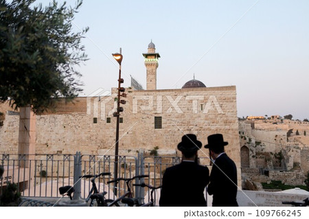 Western Wall and Worshipers in Jerusalem. The wall is one of the holiest sites in Judaism except for the Temple Mount itself. 109766245