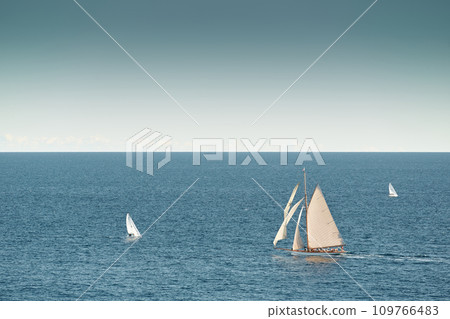 Monaco, lonely vintage sail yacht in sea at sunset, huge sail boat, wealth life of billionaires  109766483