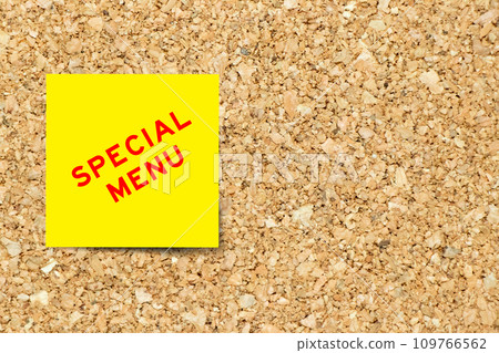 Yellow note paper with word special menu on cork board background with copy space 109766562