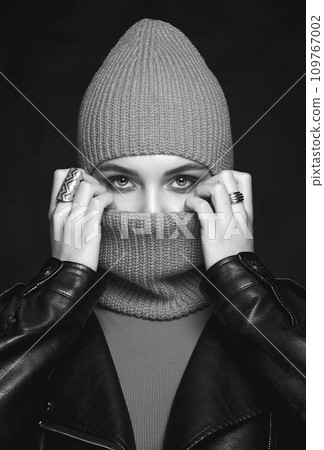 black and white portrait of beautiful girl in balaclava and leather coat black and white portrait of beautiful girl in balaclava and leather coat 109767002