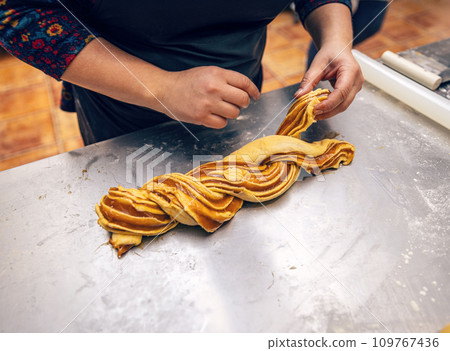 Female hands preparing a salted caramel babka. 109767436