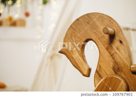 Kids tipi tent and wooden rocking horse in a room 109767901