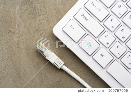 Computer keyboard with network cable close up Computer keyboard with network cable close up 109767906