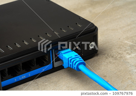 Modern router with cables plugged in close up 109767976