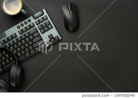 Headphones, computer mouse and keyboard on black background Headphones, computer mouse and keyboard on black background 109768049
