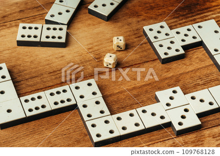 Domino game on brown wooden background close up Domino game on brown wooden background close up 109768128