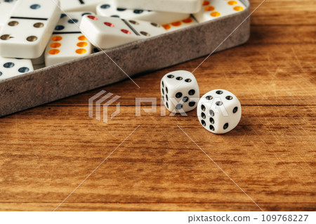Domino game on brown wooden background close up Domino game on brown wooden background close up 109768227