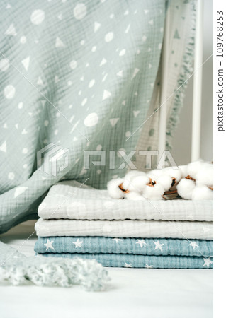 Stack of cotton blankets for a newborn in a cradle Stack of cotton blankets for a newborn in a cradle 109768253
