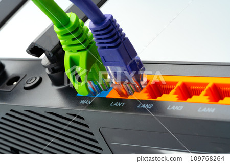 Modern router with cables plugged in close up Modern router with cables plugged in close up 109768264