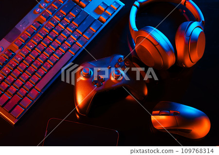 Computer keyboard, mouse and joystick on black background 109768314