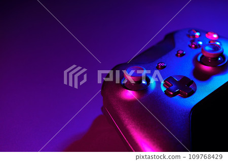 Gaming joystick on black background in neon light Gaming joystick on black background in neon light 109768429