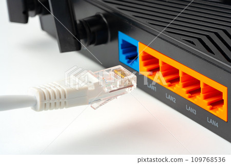 Modern router with cables plugged in close up 109768536