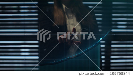 Businesswoman working on holographic financial chart using augmented reality to check economic data. Holographic elements, financial charts, icons and graphs appearing. Finance and money technology. Businesswoman working on holographic financial chart using augmented reality to check economic data. Holographic elements, financial charts, icons and graphs appearing. Finance and money technology. 109768844