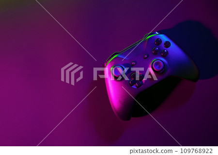 Gaming joystick on black background in neon light 109768922