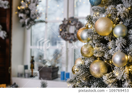 Christmas tree with toys baubles close-up on window background Christmas tree with toys baubles close-up on window background 109769453