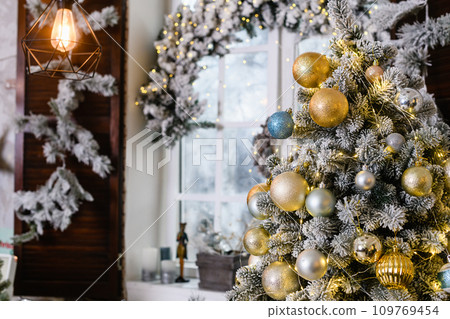 Christmas tree with toys baubles close-up on window background Christmas tree with toys baubles close-up on window background 109769454