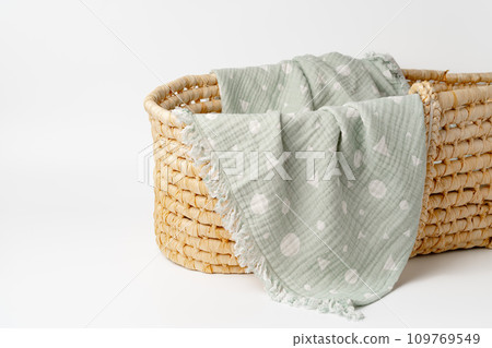 Baby cradle with muslin blanket and wooden toys in a baby room Baby cradle with muslin blanket and wooden toys in a baby room 109769549