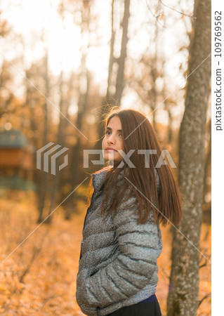 Close up portrait of pretty indian young woman enjoying warm autumn sunny day vacation outdoors. Generation z and gen z concept. Fall Season 109769562