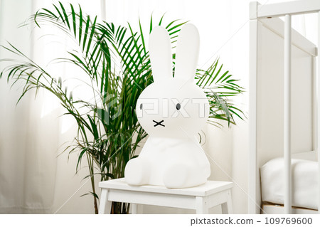 Baby wooden crib and toy rabbit in nursery room Baby wooden crib and toy rabbit in nursery room 109769600