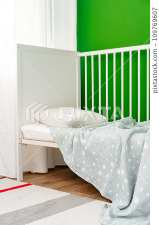 Soft cotton blanket hanging on baby's bed Soft cotton blanket hanging on baby's bed 109769607