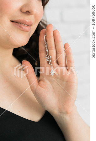 Detail of young woman wearing beautiful luxury earring. Handmade jewellery and accessories Detail of young woman wearing beautiful luxury earring. Handmade jewellery and accessories 109769650