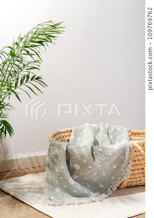 Baby cradle with muslin blanket and wooden toys in a baby room 109769762