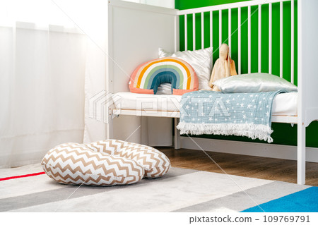 Kid's room interior with comfortable bed and rainbow pillow Kid's room interior with comfortable bed and rainbow pillow 109769791