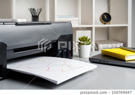 New modern printer and laptop in the office on table New modern printer and laptop in the office on table 109769947