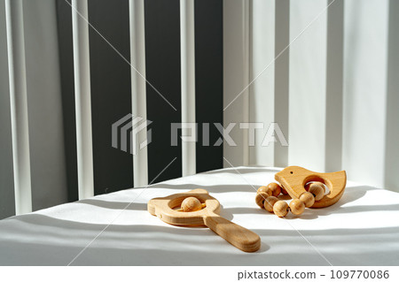 Wooden toys rattle in a baby bed 109770086