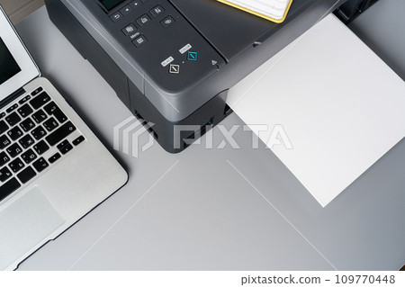 New modern printer and laptop in the office on table 109770448
