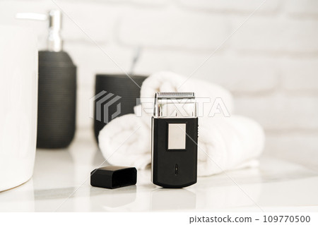 Electric shaver for men in a bathroom close up Electric shaver for men in a bathroom close up 109770500