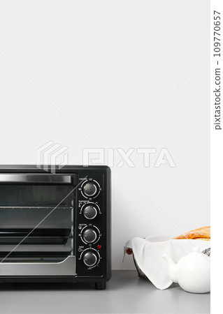 Electric mini oven on gray background studio shot 109770657