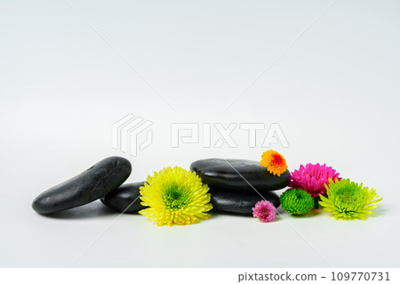 Spa stones and flowers on the white background Spa stones and flowers on the white background 109770731