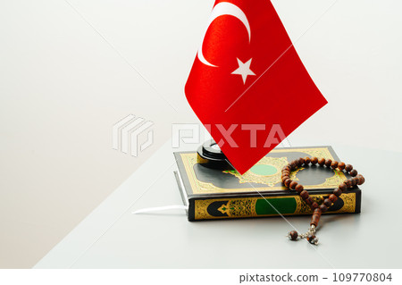 Flag of Turkey on Koran with beads on white background Flag of Turkey on Koran with beads on white background 109770804