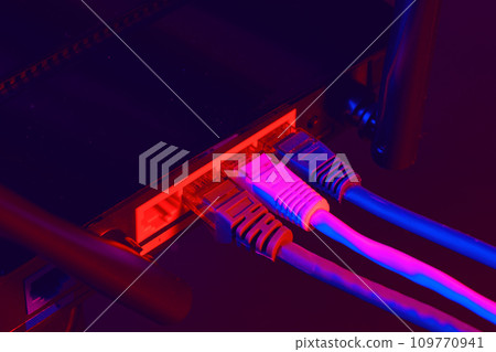 Cables plugged in a Wi-Fi router on dark background 109770941