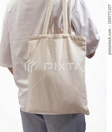 Carrying modern eco tote bag on shoulder. Woman with shopper Carrying modern eco tote bag on shoulder. Woman with shopper 109771107