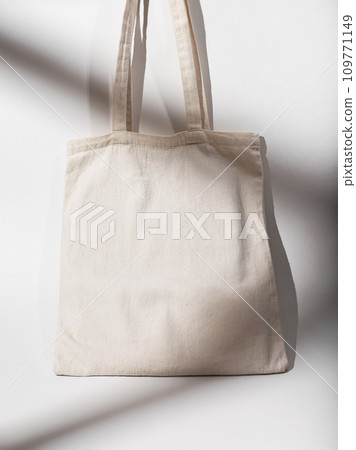 Eco tote bag. Recycled cotton textile shopper mockup, natural lighting 109771149