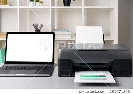 New modern printer and laptop in the office on table New modern printer and laptop in the office on table 109771206