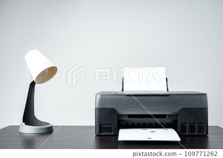 Printer with paper on gray background close up Printer with paper on gray background close up 109771262