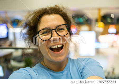 Video call portrait of excited cheerful smiling woman in spectacles taking selfie photo. Selfie and blogger concept Video call portrait of excited cheerful smiling woman in spectacles taking selfie photo. Selfie and blogger concept 109772214