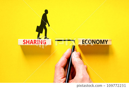 Sharing economy symbol. Concept words Sharing economy on beautiful wooden blocks. Businessman icon. Beautiful yellow table yellow background. Business sharing economy concept. Copy space. 109772231