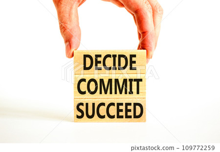 Decide commit succeed symbol. Concept word Decide Commit Succeed on beautiful wooden block. Businessman hand. Beautiful white table background. Business decide commit succeed concept. Copy space. 109772259