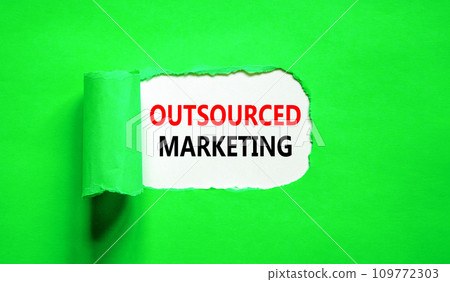 Outsourced marketing symbol. Concept words Outsourced marketing on beautiful white paper. Beautiful green paper background. Business Outsourced marketing concept. Copy space. 109772303