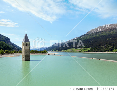 The bell tower in Reschensee and family (Italy). The bell tower in Reschensee and family (Italy). 109772475