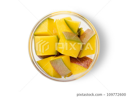 Slice of ripe organic mango with skin on white background.Top view. 109772600