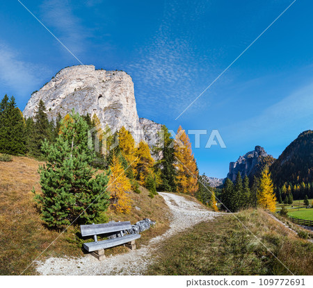 Autumn alpine Dolomites mountain scene and unrecognizable paragliders in sky, Selva di Val Gardena, Sudtirol, Italy. Autumn alpine Dolomites mountain scene and unrecognizable paragliders in sky, Selva di Val Gardena, Sudtirol, Italy. 109772691