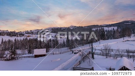 Pre-dawn alpine small quiet village and winter snowy mountains around panorama view. Pre-dawn alpine small quiet village and winter snowy mountains around panorama view. 109772973