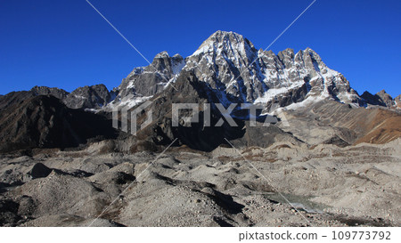 Ngozumpa Glacier and high mountains seen from Dragnang, Nepal. 109773792